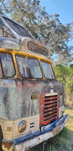 Old rusty car on field