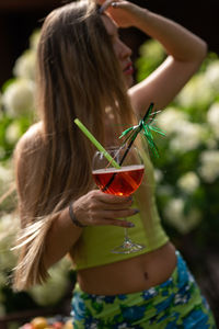 Midsection of woman holding wineglass 