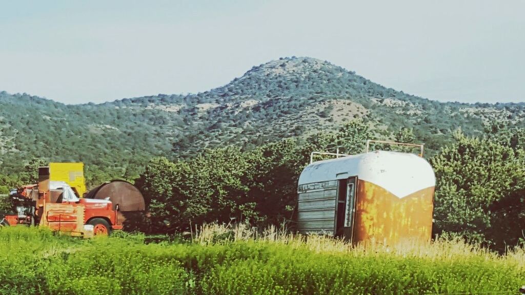 plant, land, field, landscape, rural scene, mountain, nature, farm, agriculture, grass, day, sky, environment, agricultural machinery, agricultural building, beauty in nature, growth, scenics - nature, tractor, house, outdoors, no people