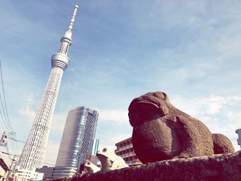 Low angle view of statue against buildings