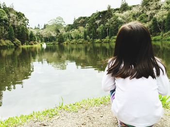 Rear view of woman looking at lake