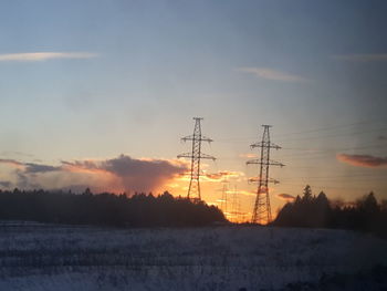 Scenic view of electricity pylon against sky during sunset