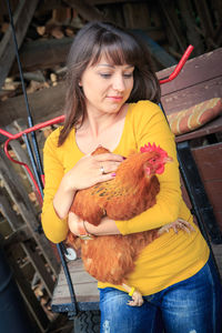 Full length of girl holding bird