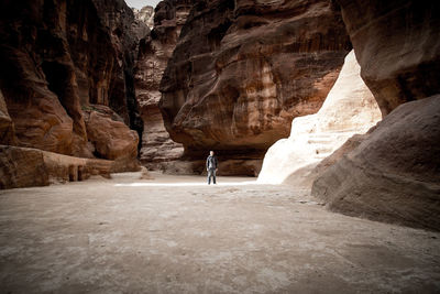 Full length of man standing amidst rock formations