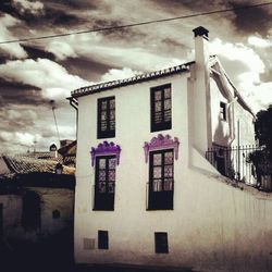 Buildings against cloudy sky