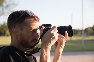 Portrait of man photographing camera
