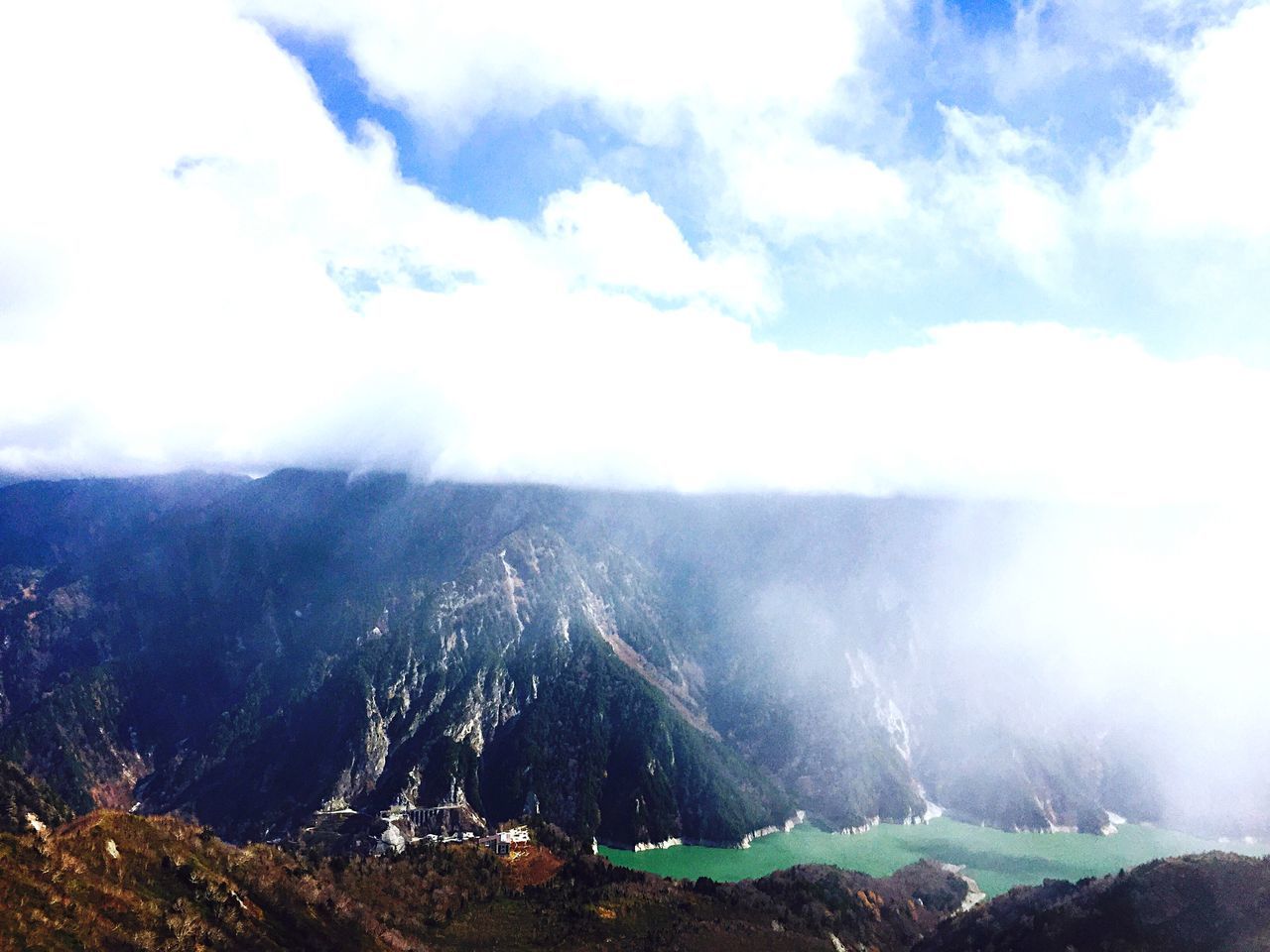 scenics, mountain, beauty in nature, tranquil scene, tranquility, sky, nature, landscape, cloud - sky, fog, mountain range, idyllic, non-urban scene, physical geography, cloud, geology, water, day, remote, outdoors