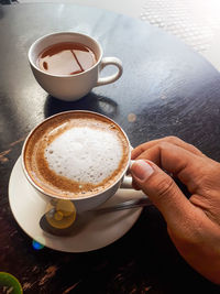 Midsection of coffee cup on table