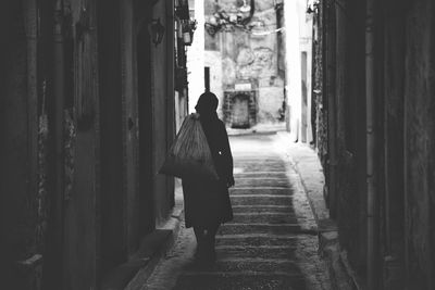 Rear view of woman walking on street