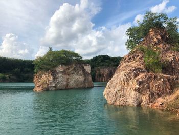 Scenic view of rocks in sea against sky