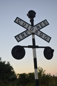 Low angle view of road sign against sky