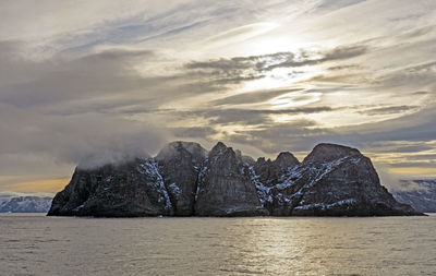 Lenticular clouds in the sun over a remote island on baffin island in nunavut, canada