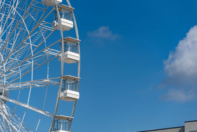 A ferris wheel set against a blue sky with copy space