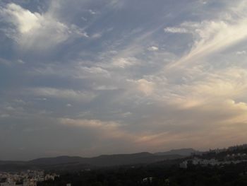 Scenic view of mountains against cloudy sky