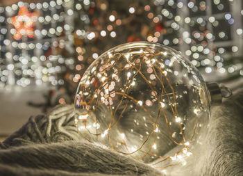 Close-up of glass bauble and christmas lights