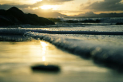 Close-up of sea against sky during sunset