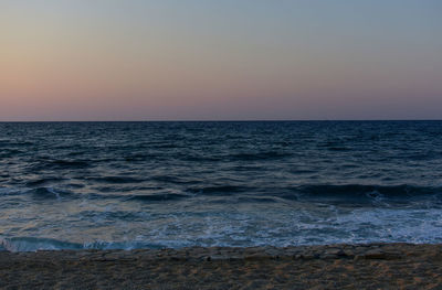 Scenic view of sea against clear sky during sunset