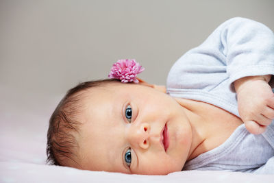High angle view of cute baby girl lying on bed at home