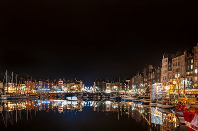 Reflection of illuminated buildings in city at night