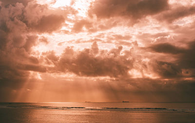 Scenic view of sea against storm clouds