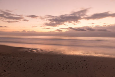 Scenic view of beach against sky during sunset