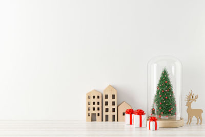 Christmas decorations on table against white background