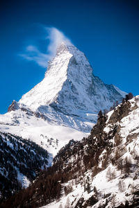 Low angle view of snowcapped mountain against sky