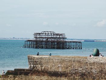 People on beach against sky