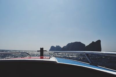 Close-up of boat in sea against clear sky