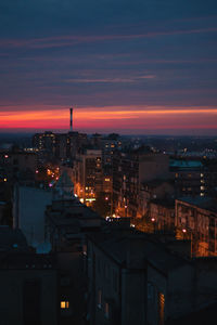 High angle view of illuminated buildings against sky during sunset