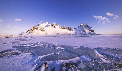 Scenic view of snowcapped landscape against sky during winter