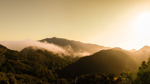 Scenic view of mountains against sky during sunset