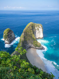 High angle view of rocks in sea against sky