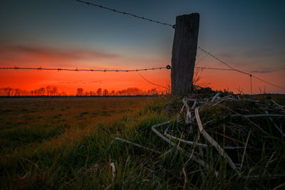 Scenic view of field against sky during sunset