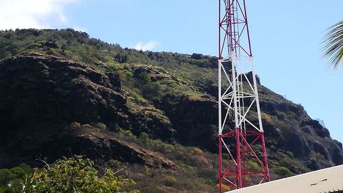 Low angle view of communications tower against sky