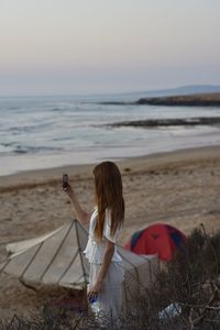 Young woman enjoying the beach sunset 