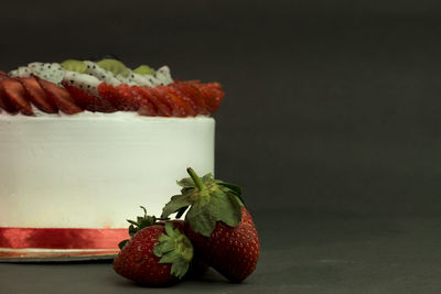 Close-up of strawberries on table against black background