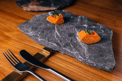 High angle view of orange bread on cutting board