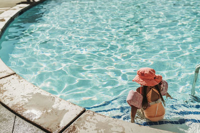 High angle view of woman standing in swimming pool