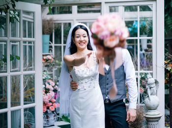 Portrait of happy couple holding flower