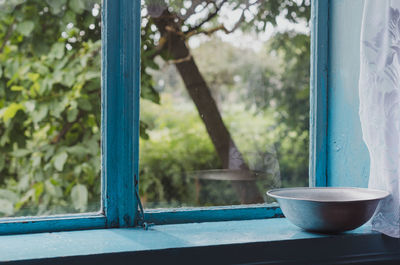 Close-up of bowl on window sill