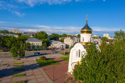 Drone view of church at street in city against sky