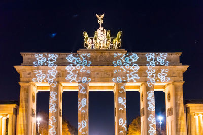 Low angle view of statues at night