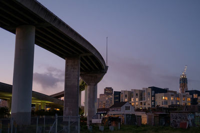 Bridge over cityscape against sky