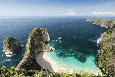 High angle view of rocks in sea against sky