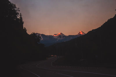 Road by mountain against sky