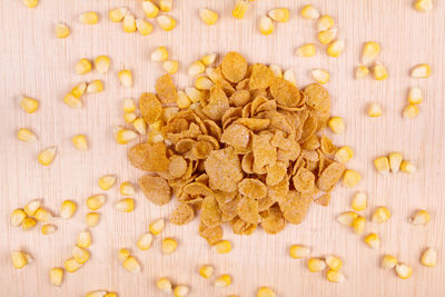 Directly above shot of sweetcorn and breakfast cereal on table