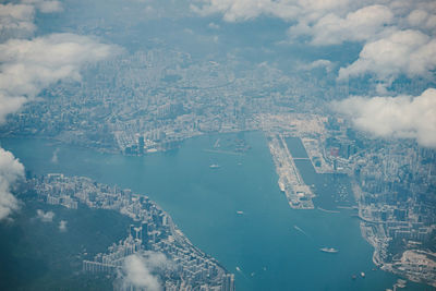 High angle view of cityscape by sea against sky