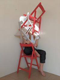 Boy sitting on chair at home