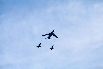 Low angle view of military airplanes flying in sky